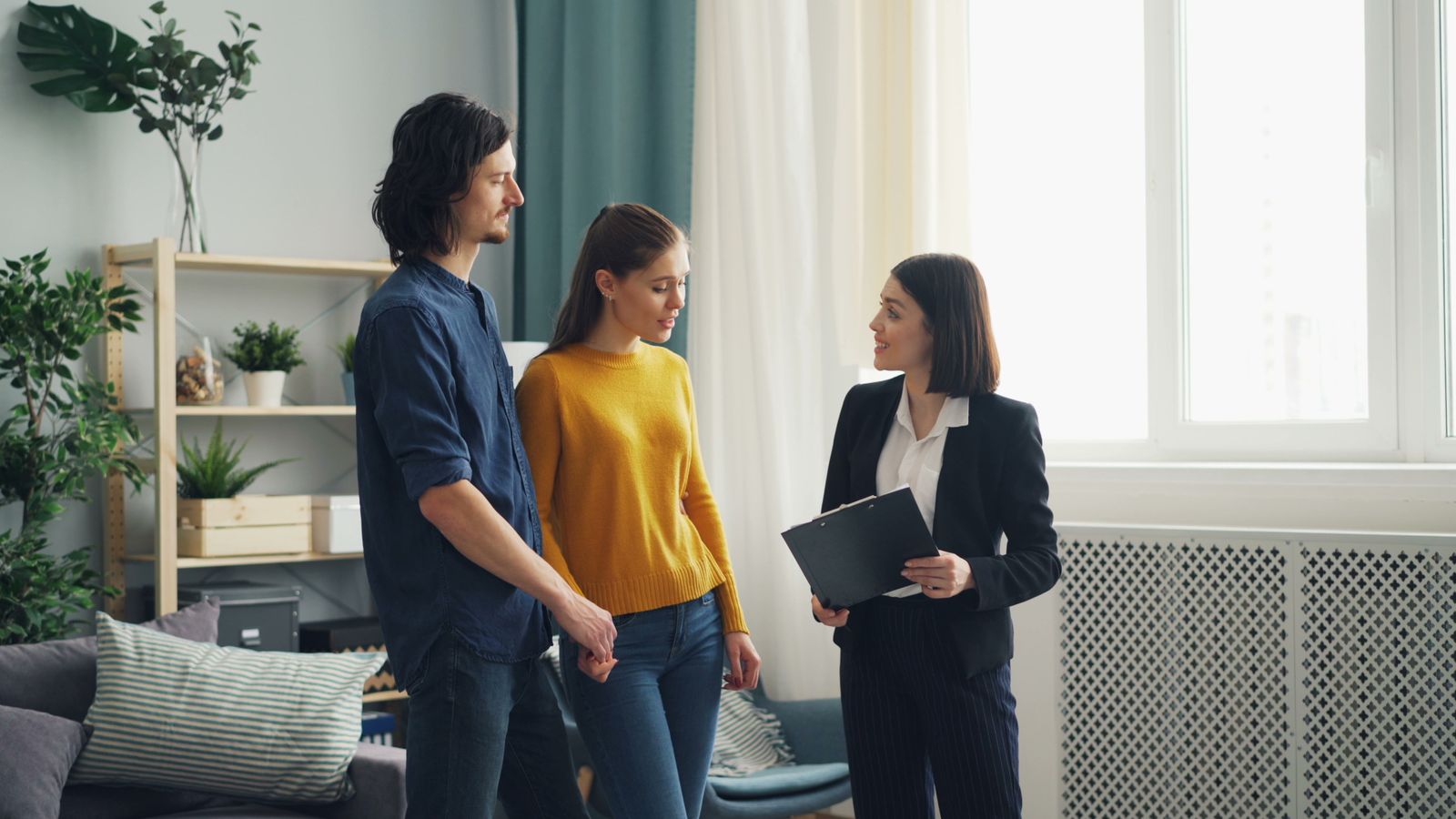 Real estate professional consulting with prospective home buyers